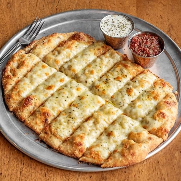 Cheesy garlic breadsticks from Little Pizza Paradise, served with marinara and ranch dipping sauces.